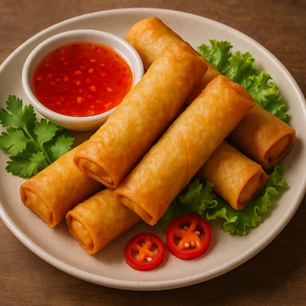 Discover a puzzle with a mouthwatering plate of golden-brown spring rolls arranged on a neutral ceramic dish, accompanied by a small bowl of bright red sweet ch