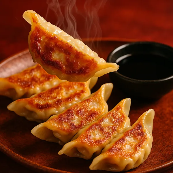 Discover a puzzle with a close-up of steaming, pan-fried gyoza dumplings — golden-brown, crispy-on-one-side wrappers lined up on a warm, reddish-brown plate bes
