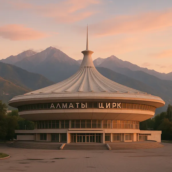 Discover a puzzle with a striking circular circus building set against a backdrop of soft, pastel sunset skies and majestic mountain peaks.