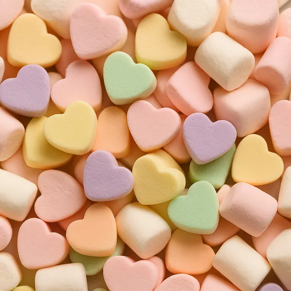 Enjoy an online jigsaw puzzle designed for browser play, featuring a close-up pile of pastel heart-shaped candies and soft marshmallows in a delightful food-the