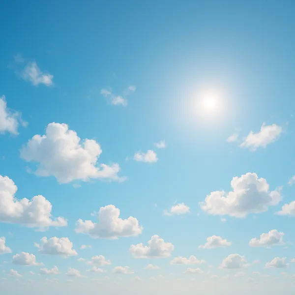 Enjoy an online jigsaw puzzle designed for browser play, featuring a tranquil nature scene of soft white clouds drifting across a clear blue sky with the sun gl