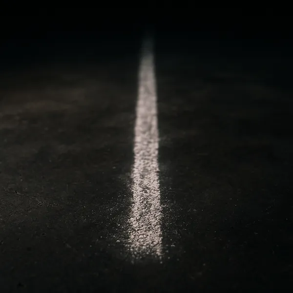 Enjoy an online jigsaw puzzle designed for browser play, featuring a minimalist urban scene with a single white road or chalk line stretching into darkness.