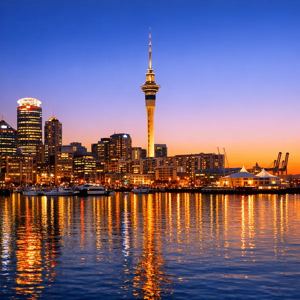 Enjoy an online jigsaw puzzle designed for browser play, featuring a tranquil city harbor at dusk with a striking skyline reflected in the water.