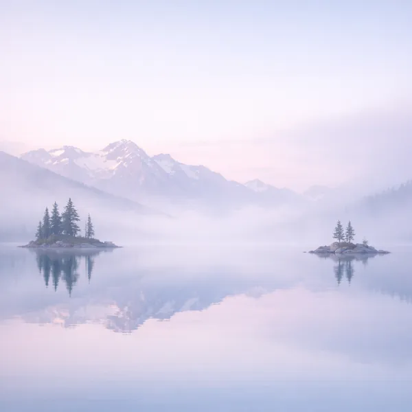 Enjoy an online jigsaw puzzle designed for browser play, featuring a serene nature scene of misty mountains and calm water.
