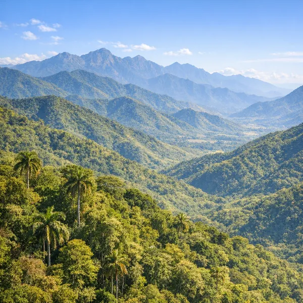 Enjoy an online jigsaw puzzle designed for browser play, featuring a lush mountain landscape and sweeping green valleys.